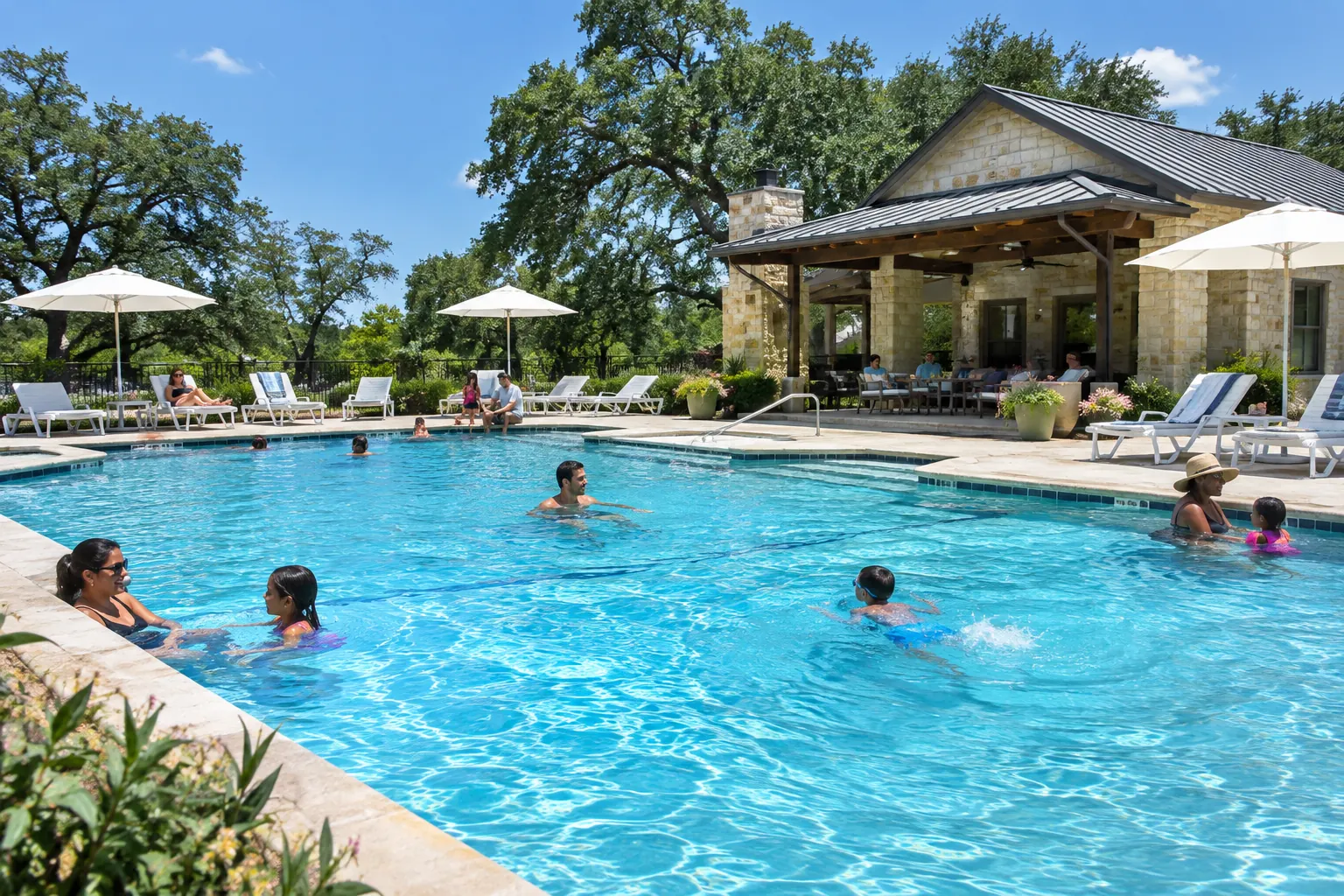 Families swimming in a community pool next to a stone clubhouse